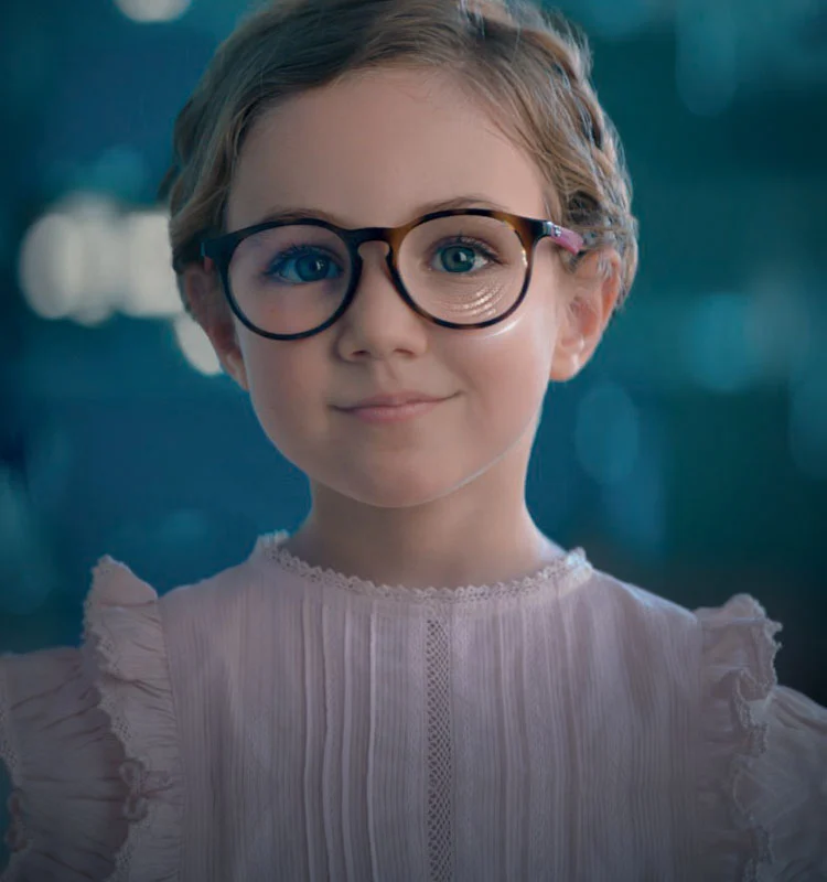 Child wearing eyeglasses in an Essilor Stellest campaign